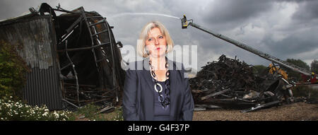 Die Innenministerin Theresa May bei den ausgebrannten Überresten des Sony Distribution Centers in Enfield North London. Stockfoto