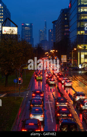 Theodor - Heuss-Allee mit Autos im Stau, Nacht und Regen mit Blick auf das Stadtzentrum mit dem Commerzbank Tower, Germa Stockfoto