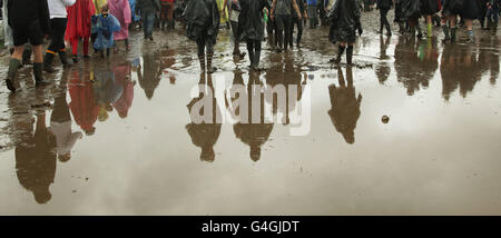 Festivalbesucher, die im Regen zum Reading Festival in der Richfield Avenue in Reading ankommen. Stockfoto