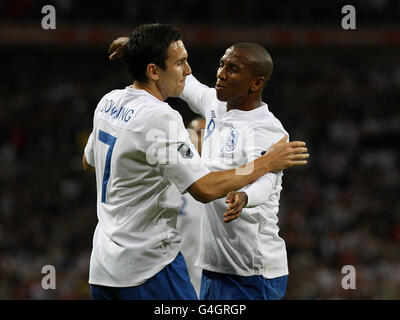 Die Engländerin Ashley Young feiert das Tor zum Eröffnungstreffer des Spiels mit Stewart Downing (links) während des UEFA Euro 2012-Qualifikationsspiels im Wembley Stadium, London. Stockfoto