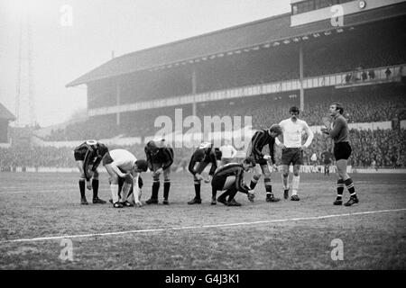 Spieler von beiden Seiten, die Glasscheiben vom Spielfeld entfernt haben, nachdem ein Ventilator eine Flasche von den Tribünen geworfen hatte. (l-r) Neil Young (Manchester City), David Jenkins (Tottenham Hotspur), Alan Oakes, Tommy Booth, Mike Doyle, Colin Bell (alle Manchester City), Mike England (Tottenham Hotspur) und Manchester City Torwart Harry Dowd. Stockfoto