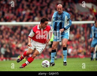 Dieses Bild darf nur im Rahmen eines redaktionellen Features verwendet werden. Marc Overmars von Arsenal tritt während ihres Premiership-Spiels in Highbury gegen den Kapitän Gary McAllister von Coventry City an. Stockfoto