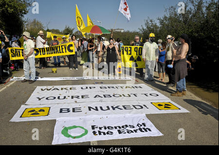 Demonstranten halten vor dem Hinkley Point-Kraftwerk in Somerset Transparente, während mehrere Anti-Atomgruppen, die Teil des Stop New Nuclear Alliance sind, gegen die Pläne von EDF Energy protestieren, den Standort mit zwei neuen Reaktoren zu erneuern. Stockfoto