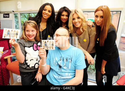 Vier Mitglieder der Samstage (von links nach rechts) Rochelle, Vanessa, Mollie und Una mit dem Patienten Peter Larkin und der Tochter Isabelle, 9, während eines Besuches auf dem neuen Gelände des Marie Curie Hospizes der West Midlands in Solihull. Frankie ist Berichten zufolge unwohl und konnte nicht teilnehmen. Stockfoto