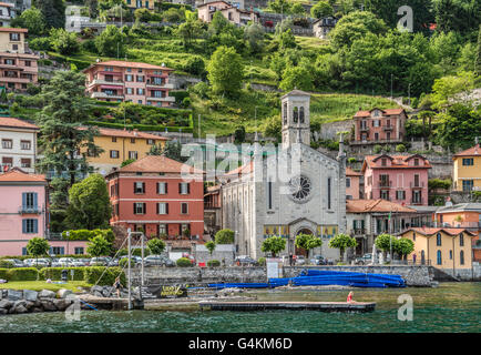 Wasser im Dorf Argegno am Comer See mit der Chiesa della Santissima Trinità gesehen vom Genfer See, Lombardei, Italien Stockfoto