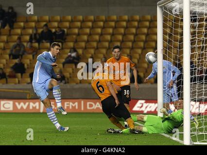 Edin Dzeko (links) von Manchester City erzielt ihr drittes Tor in der Vergangenheit Torhüter von Wolverhampton Wanderers Dorus De Vries (rechts) Stockfoto