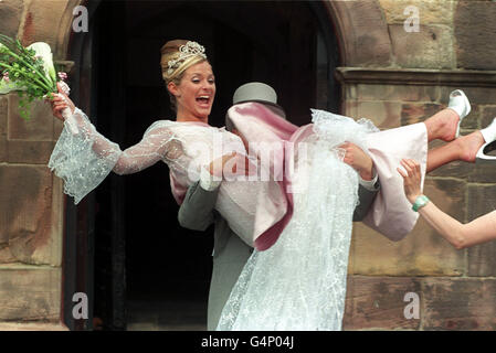 Maxine (Tracy Shaw) VON Coronation Street WIRD von ihrem Partner Ashley (Steve Arnold) nach den Dreharbeiten zu ihrer Hochzeit in der St. Mary's Church, Prestwich, in Manchester, getragen. Stockfoto