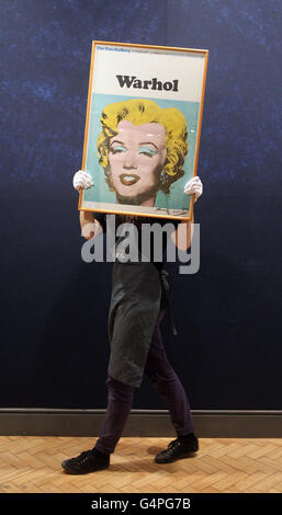 Ein Galerie-Arbeiter trägt ein signiertes Bild mit dem Titel 'Marilyn Monroe' von Andy Warhol, das schätzungsweise £1,500 bei Bonhams in ihrer Print-Auktion in London holt. Stockfoto