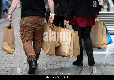 Shopper mit Primark Taschen bei Last Minute Weihnachtseinkäufen in Manchester. Stockfoto