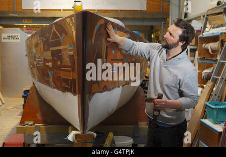 Künstler Gary Winters mit Holzobjekten, die dem Boat Project in Thornham Marina in Emsworth, Hampshire, gespendet wurden. Stockfoto