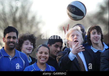 Der Londoner Bürgermeister Boris Johnson wirft Bälle in die Luft mit Schülern der Chiswick Community School im Westen Londons, wo er und der Londoner 2012-Vorsitzende Lord Coe der Schule mitteilten, wie viele olympische Tickets sie über das Londoner Ticketshare-Programm 2012 erhalten würden. Stockfoto