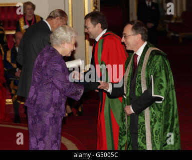 Queen Elizabeth II und der Duke of Edinburgh verleihen Professor Michael Arthur (rechts) und Professor John Fisher CBE von der University of Leeds im Buckingham Palace im Zentrum von London einen Royal Anniversary Prize for Higher and Further Education. Stockfoto