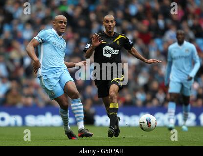 Fußball - Barclays Premier League - Manchester City / Bolton Wanderers - Etihad Stadium. Vincent Kompany (links) von Manchester City in Aktion mit Darren Pratley von Bolton Wanderers Stockfoto