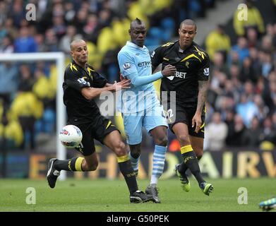 Fußball - Barclays Premier League - Manchester City / Bolton Wanderers - Etihad Stadium. Mario Balotelli (Mitte) von Manchester City in Aktion mit Darren Pratley von Bolton Wanderers (links) und Zat Knight kämpfen um den Ball Stockfoto