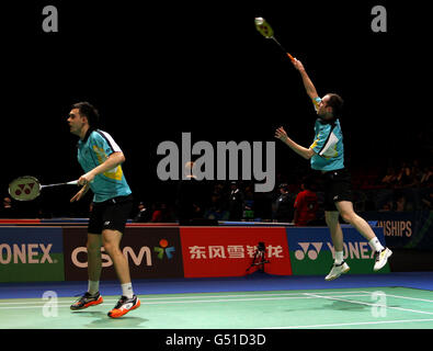 Der englische Andrew Ellis kehrt zurück, beobachtet von seinem Spielpartner Chris Adcock während der Yonex All England Badminton Championships in der National Indoor Arena in Birmingham. Stockfoto