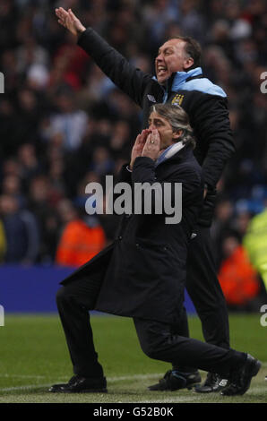 Manchester City Manager Roberto Mancini und Assistent David Platt rufen Anweisungen während des Spiels der Barclays Premier League im Etihad Stadium, Manchester. Stockfoto