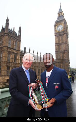 Sir Menzies Campbell posiert mit seinen Studentenspielen und Medaillen auf der Westminster Bridge im Zentrum von London, zusammen mit dem Studenten und dem Olympischen Hoffnungsträger Tremayne Gilling, während der Eröffnung der Universities Week. Stockfoto