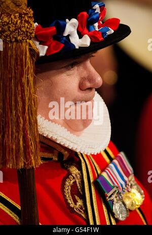 Yeoman of the Guard trägt traditionelle Uniform, während sie darauf warten, dass Königin Elizabeth II. Während der Eröffnung des Londoner Parlaments durch die Royal Gallery im Palace of Westminster geht. Stockfoto