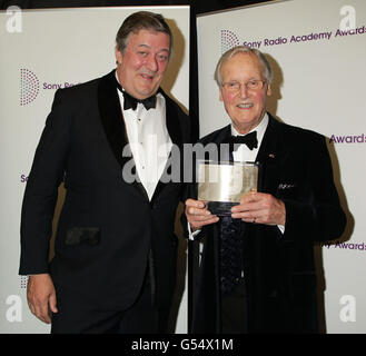 Moderator Stephen Fry (links) mit Nichola Parsons, der bei den Sony Radio Academy Awards den Gold Award gewonnen hat, im Grosvenor House Hotel im Zentrum von London. Stockfoto