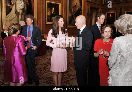 Der Herzog und die Herzogin von Cambridge und Prinz Harry sprechen mit den Gästen während eines Empfangs im Waterloo Chamber, bevor sie ihr Jubilee Lunch der Souveränen Monarchen im Schloss Windsor einnehmen. Stockfoto