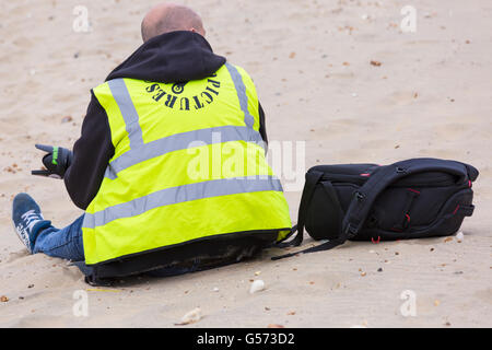 Fotograf am Strand tragen Hallo Vis Weste in Bournemouth Räder Festival im Juni Stockfoto