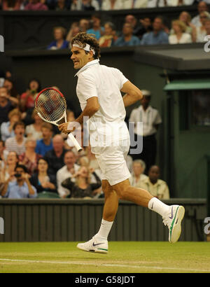 Der Schweizer Roger Federer feiert den Sieg im vierten Satz gegen den Franzosen Julien Benneteau am fünften Tag der Wimbledon Championships 2012 im All England Lawn Tennis Club in Wimbledon. Stockfoto