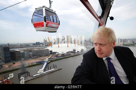 Der Londoner Bürgermeister Boris Johnson fährt eine der ersten Fahrten mit der Emirates Air Line Seilbahn über die Themse in London, bevor sie heute Morgen offiziell eröffnet wird. Stockfoto