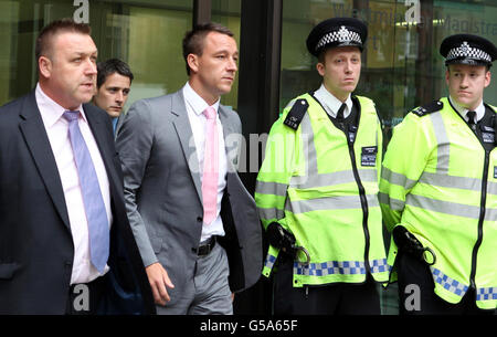 Chelsea-Kapitän John Terry verlässt das Westminster Magistrates' Court, London, wo er vor Gericht gestellt wird, weil er seinen Fußballer Anton Ferdinand rassistisch missbraucht hat. Stockfoto