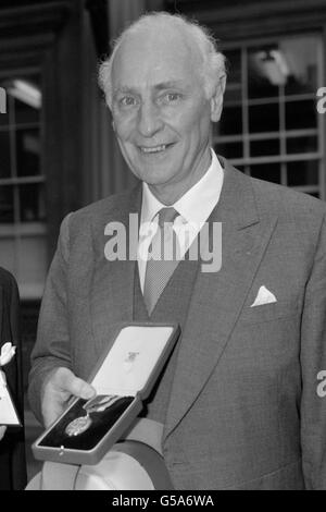 Der Gouverneur der Bank of Scotland, Sir Thomas Risk (r), im Buckingham Palace, als er bei einer Investitur der Queen zum Ritter geschlagen wurde. Stockfoto