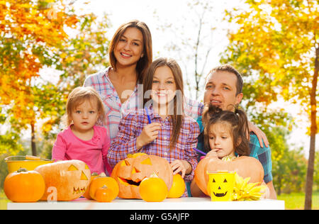 Familie schnitzen gruselige Kürbisse im Garten Stockfoto