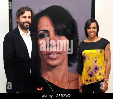 Dame Kelly Holmes Großbritanniens Doppel-Goldmedaille-Athletin steht neben einem neuen großen Porträt ihrer selbst mit dem Künstler Craig Wylie in der National Portrait Gallery im Zentrum von London. Stockfoto