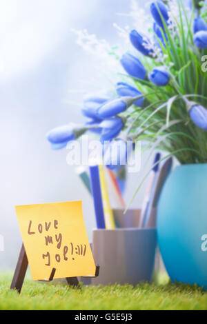 Selbstklebende Hinweis mit Liebe meinen Job Text im grünen Büro Stockfoto