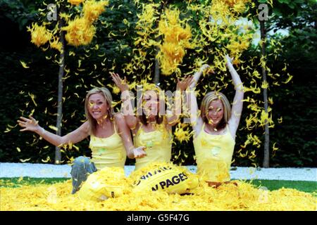 Die Popgruppe Atomic Kitten (von links) Jenny Frost, Liz Maclarnon und Natasha Hamilton lassen während einer Fotoschau in London Federn fliegen, um die neue, mit Küken bedeckte Yellow Pages Diretory zu lancieren. Stockfoto