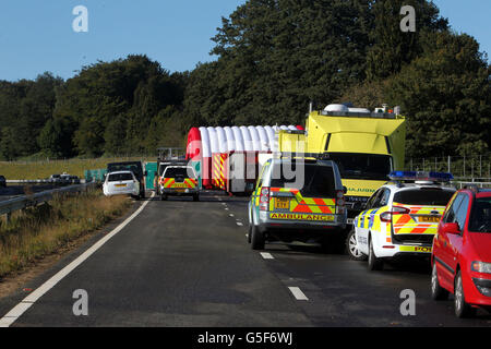 Rettungsdienste am Unfallort auf der A3 bei Hindhead in Surrey, wo drei Menschen starben und andere schwer verletzt wurden, als der Bus nach dem Zusammenprall mit einem Baum auf einem Damm umkippte. Stockfoto