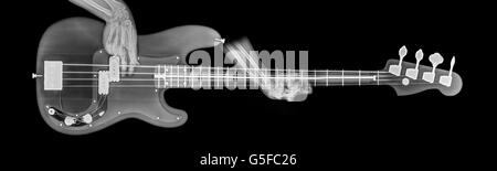 Hände spielen Basis Gitarre unter Röntgenkontrolle Stockfoto