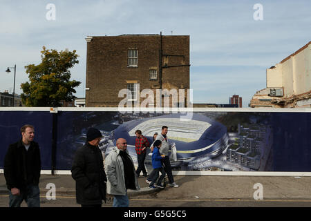 Die Fans gehen an den Schlaufen vorbei, die einen Künstlereindruck von den Plänen der Vereine zeigen, ein neues Stadion neben der White hart Lane zu bauen Stockfoto