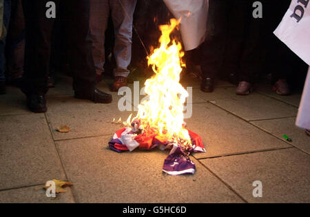 Bei einer Demonstration gegen die von den USA angeführten Bombardierungen Afghanistans vor der Londoner Central Mosque des Regent Park in London wird leichteres Benzin auf eine bereits in Flammen stehende amerikanische Flagge gegossen. *...die Demonstration, an der bis zu 125 Muslime teilgenommen haben, folgte den Mittagsgebeten, die friedlich vergingen und mehr als tausend gezählt hatten. Stockfoto