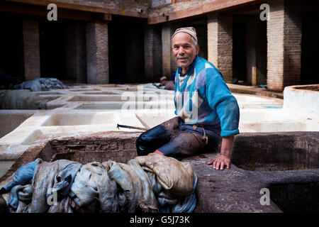 Fes, Marokko - 11. April 2016: Ein Mann, der arbeitet in einer Gerberei in der Stadt Fez in Marokko. Stockfoto