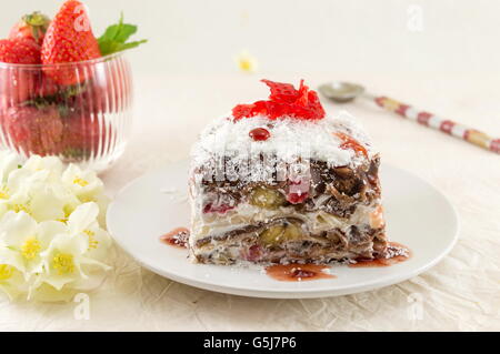 Serviert auf einem weißen Teller mit frischen Erdbeeren Erdbeerkuchen Stockfoto