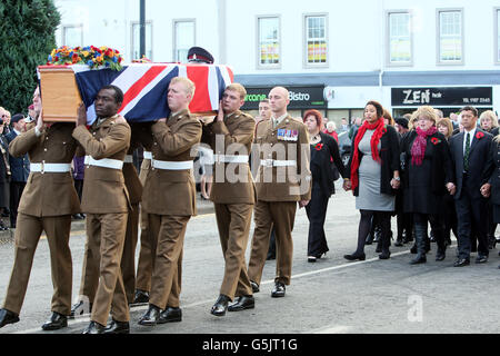 Leslie (rechts) und Rosemary (zweite rechts), Eltern von Corporal Channing Day, die in Afghanistan getötet wurde, gehen mit ihrem Bruder Aaron und den Schwestern Lauren und Lakan hinter ihren Sarg, wie er vor ihrer Beerdigung durch Comber, Co Down, getragen wird. Stockfoto