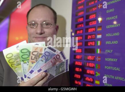 Simon Phillips, Travelex Director of European Retail Operations, hält eine Handvoll neuer Euro-Banknoten in der Niederlassung des Heathrow Airport Terminal 1. * der Direktor und seine Mitarbeiter in der Geldwechselstube gewöhnen sich an die Euro-Währung, die in 12 europäischen Ländern verwendet werden wird. Stockfoto