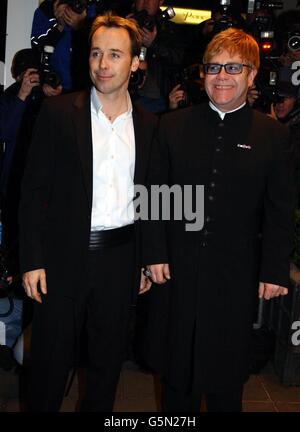 Sir Elton John (rechts) und sein Partner David Furnishe kommen im Dorchester Hotel in London an, wo er den ersten UKC Hero Award der UK Coalition of People Living with HIV and AIDS (UKC) erhalten wird. * der Preis würdigt seinen herausragenden Beitrag zur weiteren Bekämpfung von HIV und AIDS im Vereinigten Königreich. Stockfoto