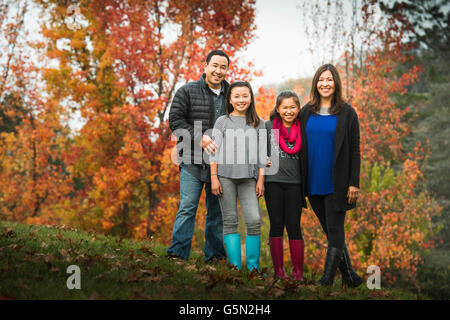 Familie lächelnd auf Herbst Hügel Stockfoto