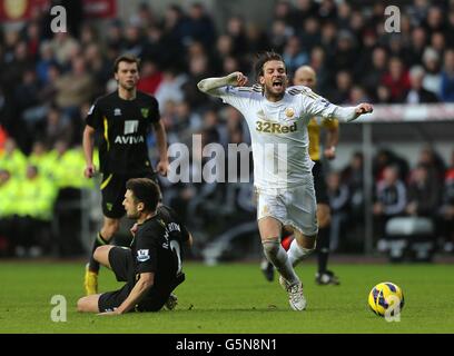 Miguel Michu (rechts) von Swansea City geht unter die Herausforderung Russell Martin von Norwich City (links) Stockfoto