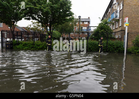 London, Großbritannien. 23. Juni 2016. Starker Regen verursacht überschwemmungen in East London, Canning Town. Drei Feuerwehrmänner das Waten durch die überschwemmten Straßen. Quelle: ZEN-Zaneta Razaite/Alamy leben Nachrichten Stockfoto