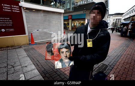 Gesicht und ID-Tag wurden verpixelt, um die Identifikation zu verbergen. Ein großer Verkäufer außerhalb von Sainsbury's in der Union St, Birmingham, wo zwei Männer in der Nähe voneinander tödlich erstochen wurden. Stockfoto