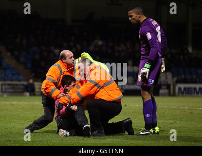 Ein junger Gillingham-Fan wird von Stewards angegriffen, nachdem er während des npower League Two-Spiels im MEMS Priestfield Stadium, Gillingham, auf Wycombe-Torwart Jordan Archer gesprungen ist. Stockfoto