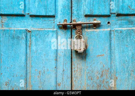 Vorhängeschloss an einem blauen Grunge Tür in Nepal Stockfoto