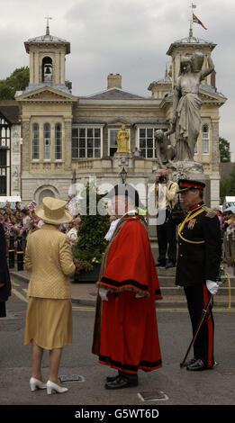 Die britische Königin Elizabeth II. Erstartet das Market House in Kingston im Stadtzentrum von Thames, begleitet von dem Bürgermeister Don Jordan (Mitte) und dem stellvertretenden Oberstleutnant Geoffrey Godbold während ihres Golden Jubilee-Besuches in West London. Stockfoto