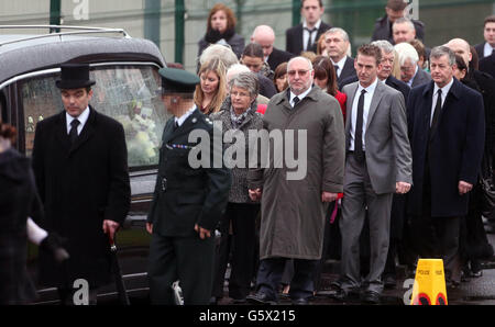 GESICHT VERPIXELT DURCH AUF ANFRAGE DES PSNI. Constable Philippa Reynolds Eltern Mervyn und Dorothy gehen hinter ihrem Sarg in der Mossley Methodist Church, Newtownabbel. Stockfoto